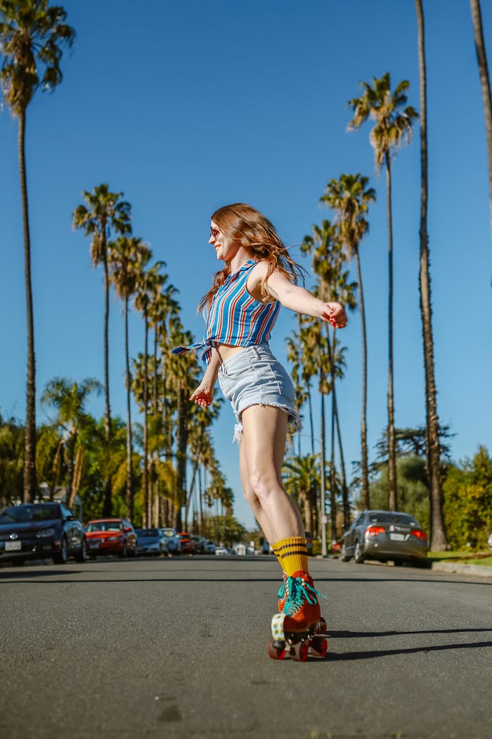 Crafting Captivating Headlines: Your awesome post title goes here A carefree woman roller skating on a palm-lined street under a clear blue sky.